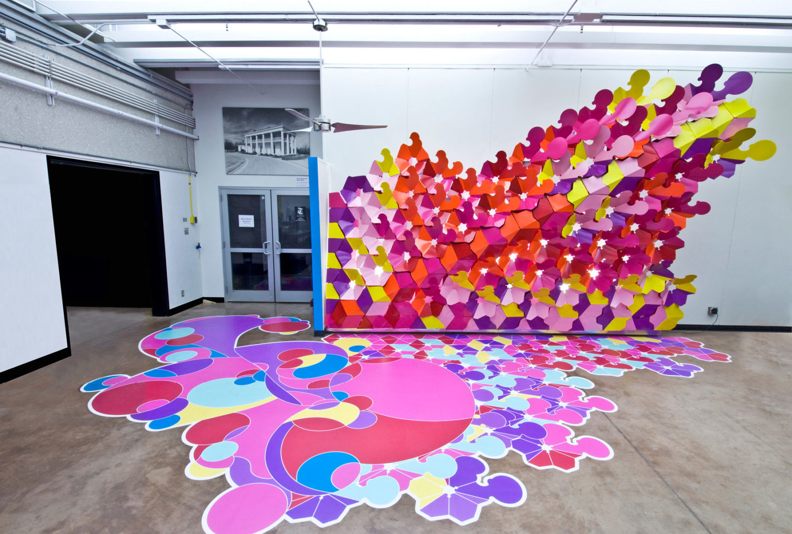 Wall installation with formed metal petals by Arktura Solutions Studio for Texas A&M University's Azimuth Café.