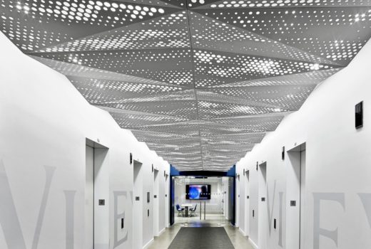 Delta Drop® 2x4 full circle with backlight installed above elevator lobby.