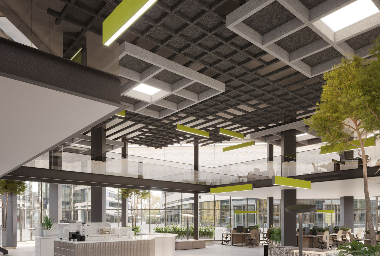 Open office space with ample seating areas. There is a tree inside the space. There are green, gray and white ceiling panels.