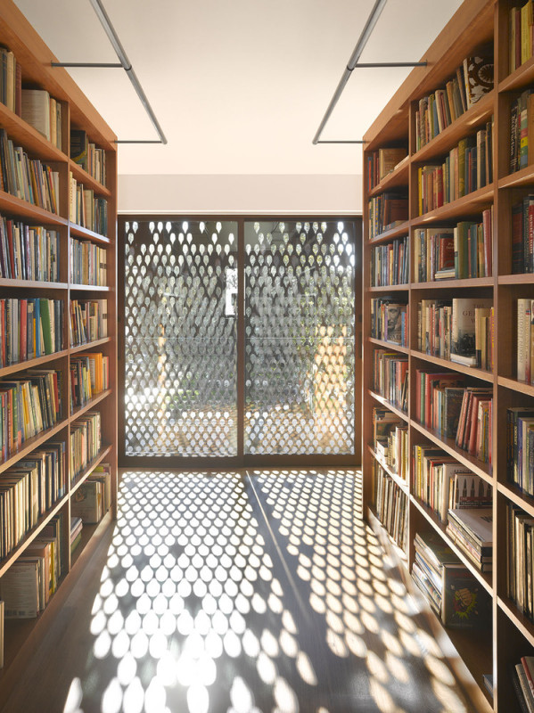 Interior view of the Morgan Phoa Library and Residence. The perforated siding lets specs of light into the library.
